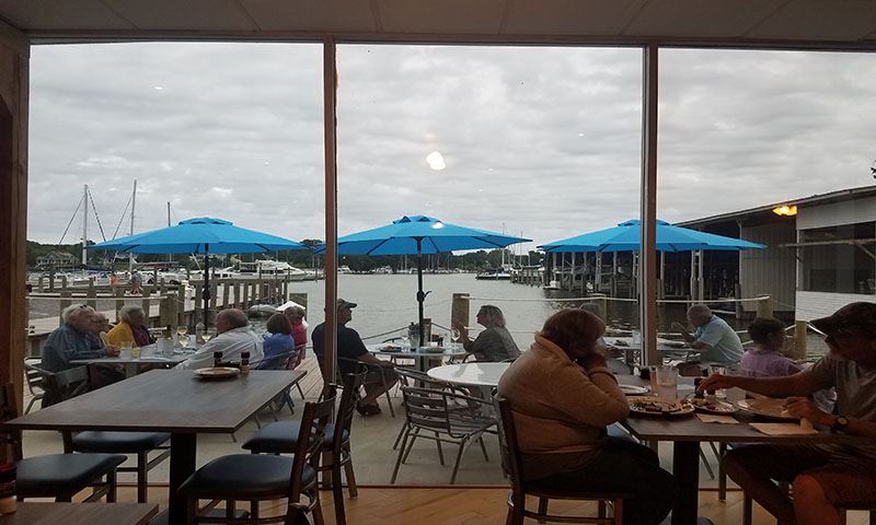 Customers enjoying indoor and outdoor tables at the Portside Grill
